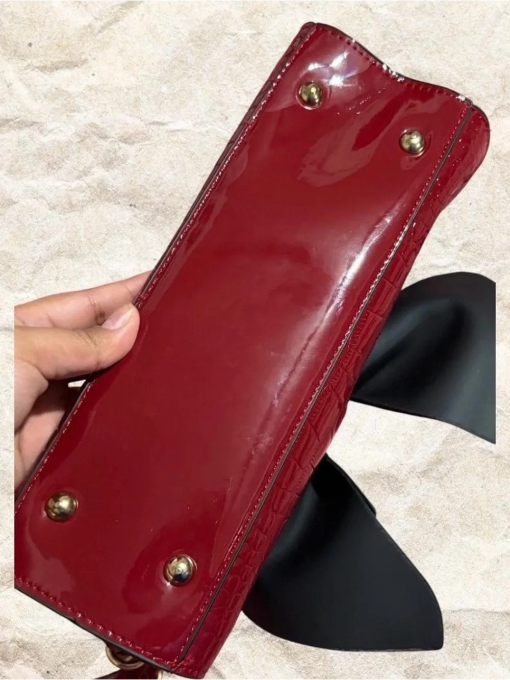 Red crocodile textured bow bag with gold hardware with removable strap